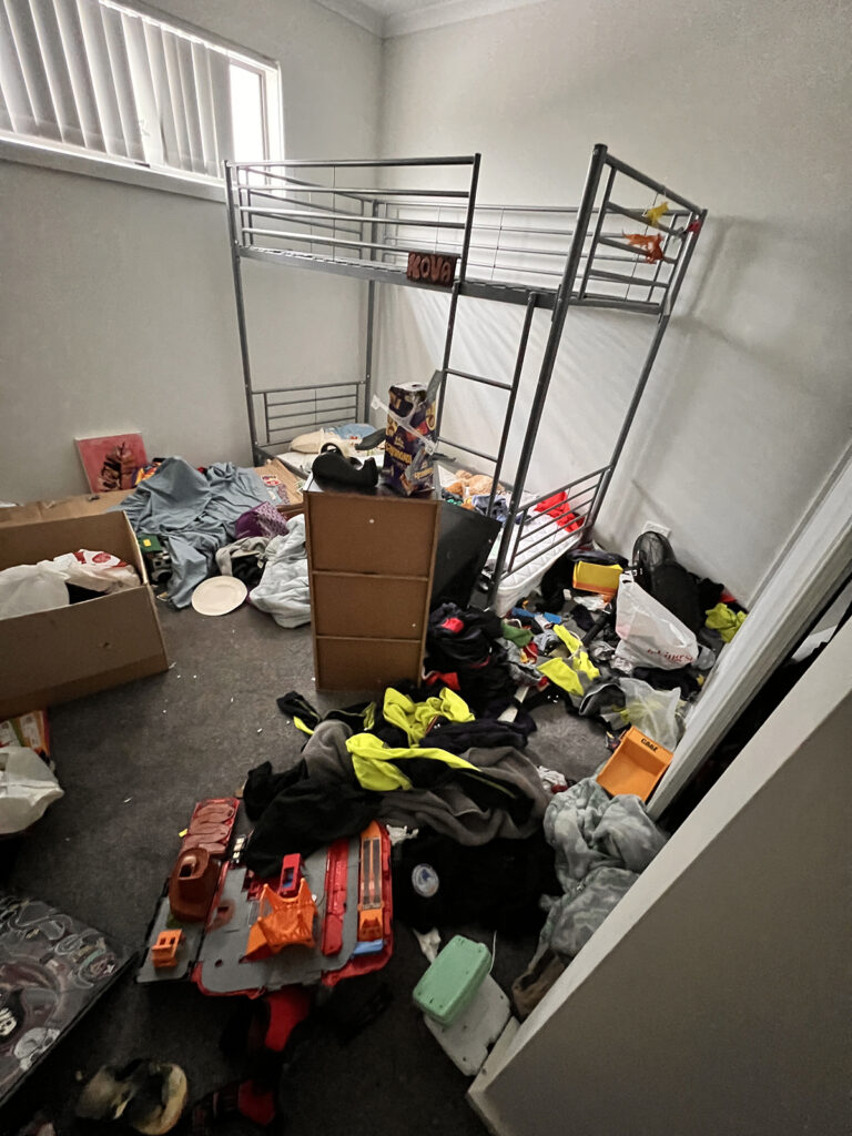 Mitch Vahldieck -- the young boy's bedroom. There doesn't appear to be any quilt or blanket (or sheets) on the bed, 2023