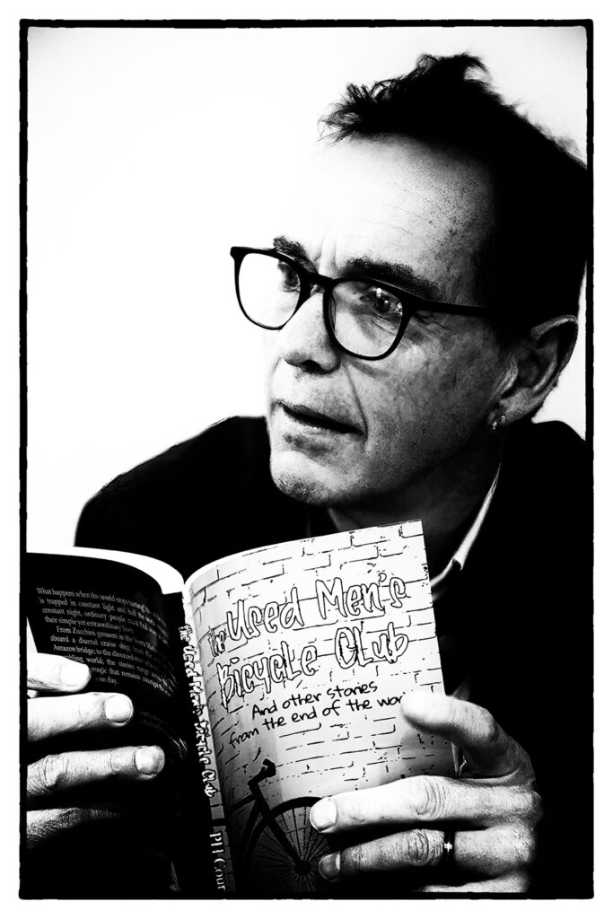 Dr Pete Court with a copy of his 2023 book, 'The Used Men's Bicycle Club', Adelaide 2023